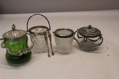 three glass and silver teapots and a glass teapot on a white table