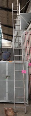 a man that is standing on a ladder in a building