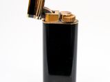 an image of a black lighter with gold trim on a white background