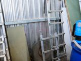 a blue barrel sitting in a room with a ladder next to it