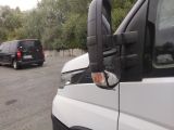 a white van parked in a parking lot next to a black van