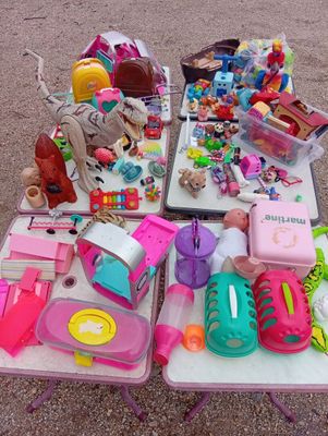 a table full of toys and toys for sale on the street