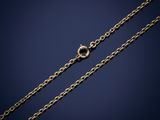 a gold chain with a clasp on a dark background