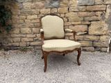 a chair that is sitting in front of a stone wall