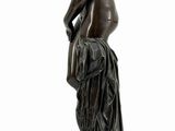 bronze statue of a woman with a dog on a pedestal