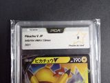 the pokemon card is in a plastic case on a table