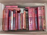 a box full of books sitting on a shelf