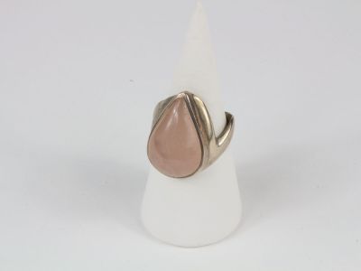 a close up of a ring with a tear shaped stone on it