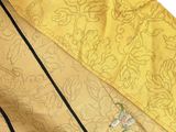 a close up of a yellow umbrella with a black handle