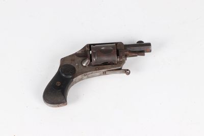 an old gun on a white surface with a white background
