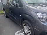 a black van parked in a parking lot next to a building