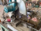 a machine that is sitting on a workbench in a garage