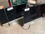two computer monitors sitting next to each other on the floor