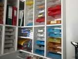 a kitchen with a lot of containers and dishes on the shelves