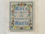 a picture of a cross stitch picture on a white frame