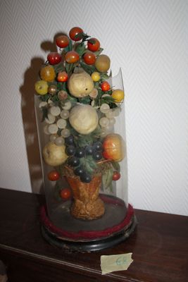 a vase with a bunch of fruit in it on a table