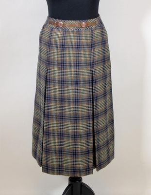 the skirt is made of plaid fabric and has a brown belt