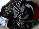 a pile of clothes sitting on top of a bed