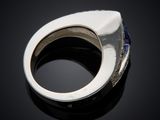 a close up of a silver ring with a blue stone in it