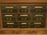 a wooden dresser with many drawers and drawers on top of it