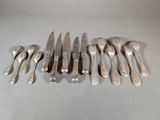 a lot of forks and spoons that are on the table
