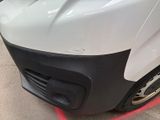 a close up of a white truck with a red light on it