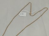 a gold chain necklace with a tag on it