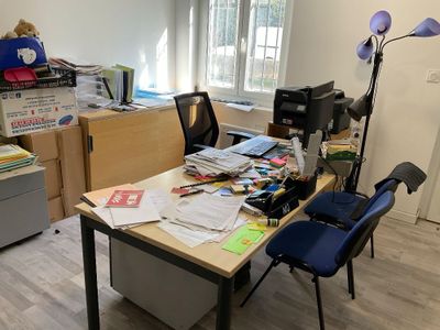 a desk with a chair and a lamp in the corner of the room