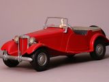 a red toy car that is sitting on a table