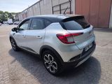 the rear end of a silver car parked in a parking lot