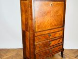 an old wooden chest of drawers sitting on top of a hard wood floor