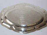 a silver plate on a white table with a white background