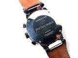 a close up of a watch on a white surface