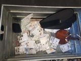 a suitcase with a bunch of cards and a cell phone in it