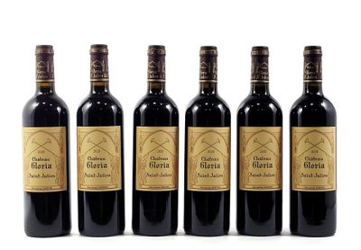 six bottles of wine are lined up on a white surface