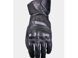 une photo d'une paire de gants de moto noirs sur fond blanc