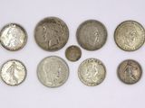 a close up of a bunch of coins on a white surface