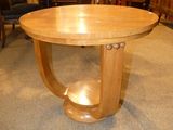 a wooden table with a wooden base in a room