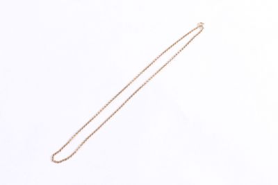 a close up of a necklace on a white surface with a white background