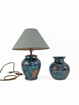 two blue vases sitting next to each other on a white surface