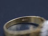 a close up of a wedding ring with a diamond