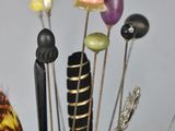 a vase with a bunch of pins and needles in it