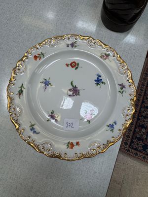 a white plate with a floral design on it on a table