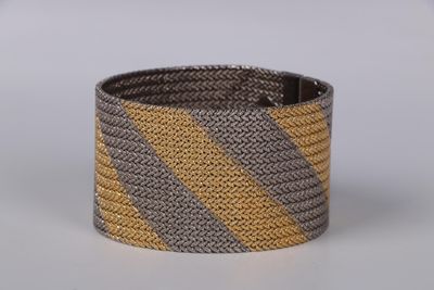 grey and yellow striped bracelet with a metal clasp
