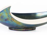 a silver and blue bowl with a black handle
