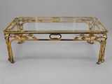 a brass coffee table with glass top