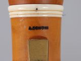 a close up of a vase with a wooden handle