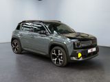 the grey jeep compass is parked in a room with a white wall
