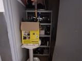 a box sitting on top of a toilet in a room