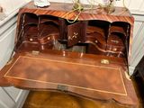 a wooden desk with a drawer on top of it